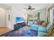 Inviting living room with galaxy carpet, comfy blue sectional, and large windows with colorful curtains at 4801 71St N St, St Petersburg, FL 33709
