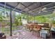 Covered wooden patio with ceiling fan, ideal for outdoor dining and relaxation at 4801 71St N St, St Petersburg, FL 33709