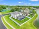 Areal view of a meticulously landscaped backyard, complete with a pool, and a charming fire pit at 4805 Holdsworth Dr, Land O Lakes, FL 34639