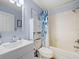 Full bathroom with shower-tub combo, blue accents, and linen storage at 4805 Holdsworth Dr, Land O Lakes, FL 34639