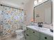Charming bathroom featuring animal-themed shower curtain, green vanity, and decorative mirror at 4805 Holdsworth Dr, Land O Lakes, FL 34639