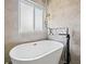 Close-up view of a contemporary bathtub with modern fixtures and a decorative niche at 4805 Holdsworth Dr, Land O Lakes, FL 34639