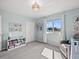 Bright bedroom with plush carpeting and a cozy gray armchair near the window at 4805 Holdsworth Dr, Land O Lakes, FL 34639