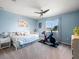 Inviting bedroom with a cozy daybed, ceiling fan, and exercise equipment near the window at 4805 Holdsworth Dr, Land O Lakes, FL 34639