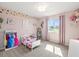 Bright bedroom with pink walls, carpeted floor, princess decor, and natural light at 4805 Holdsworth Dr, Land O Lakes, FL 34639
