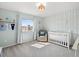 Bedroom with soft blue walls, carpet, crib, and natural light at 4805 Holdsworth Dr, Land O Lakes, FL 34639