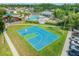 Aerial view showcasing a pool, basketball court, and playground within the community at 4805 Holdsworth Dr, Land O Lakes, FL 34639