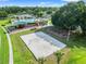 Aerial view showcasing a playground, sand volleyball court and swing sets within a park at 4805 Holdsworth Dr, Land O Lakes, FL 34639