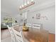 Well-lit dining room with wood table, seating for six, and views into the foyer and living areas at 4805 Holdsworth Dr, Land O Lakes, FL 34639