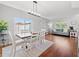 Bright dining area featuring hardwood floors, a modern light fixture, and a large window offering natural light at 4805 Holdsworth Dr, Land O Lakes, FL 34639