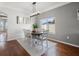 Comfortable dining space with wood floors, a geometric rug, and ample natural light from a large window at 4805 Holdsworth Dr, Land O Lakes, FL 34639