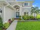 Charming front entrance with a blue door, complemented by a landscaped garden at 4805 Holdsworth Dr, Land O Lakes, FL 34639