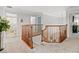 Bright hallway with wood railing leading to multiple rooms at 4805 Holdsworth Dr, Land O Lakes, FL 34639