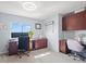 Bright home office featuring dual monitors, custom cabinetry, and comfortable seating at 4805 Holdsworth Dr, Land O Lakes, FL 34639