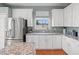 Kitchen featuring stainless appliances, granite countertops, and white cabinetry at 4805 Holdsworth Dr, Land O Lakes, FL 34639