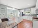 Spacious kitchen with white cabinets, a center island, stainless appliances, and tile flooring at 4805 Holdsworth Dr, Land O Lakes, FL 34639
