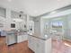 Open kitchen featuring a granite island, stainless sink, and views into the living room at 4805 Holdsworth Dr, Land O Lakes, FL 34639