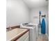 Practical laundry room with washer, dryer, sink, and ample counter space at 4805 Holdsworth Dr, Land O Lakes, FL 34639