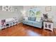 Bright and airy living room with hardwood floors and a comfortable blue sofa at 4805 Holdsworth Dr, Land O Lakes, FL 34639