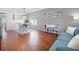 Open-concept living area with dining space, featuring hardwood floors and soft gray walls at 4805 Holdsworth Dr, Land O Lakes, FL 34639