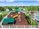 Aerial view of the community playground with multiple play structures and seating area at 4805 Holdsworth Dr, Land O Lakes, FL 34639