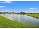Scenic view of a tranquil pond surrounded by lush greenery and well-maintained lawns at 4805 Holdsworth Dr, Land O Lakes, FL 34639