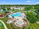 Aerial view of a community pool featuring lounge chairs and a hot tub surrounded by lush greenery at 4805 Holdsworth Dr, Land O Lakes, FL 34639