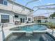 Screened-in pool and hot tub area with a pristine pool and outdoor seating, perfect for relaxing at 4805 Holdsworth Dr, Land O Lakes, FL 34639