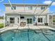 The screened-in pool area offers a refreshing escape, featuring a pristine pool and comfortable seating at 4805 Holdsworth Dr, Land O Lakes, FL 34639