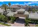 Aerial view of the community entrance with lush landscaping, palm trees, and building 501 at 501 Knights Run Ave # 5103, Tampa, FL 33602