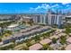 Stunning aerial view with lush trees, resort-style tennis courts, and downtown cityscape at 501 Knights Run Ave # 5103, Tampa, FL 33602