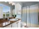 Charming bathroom featuring a granite vanity top, ample storage, and a shower with a blue curtain at 501 Knights Run Ave # 5103, Tampa, FL 33602