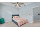 Inviting bedroom with a soft pink comforter, ceiling fan and view to the hall at 501 Knights Run Ave # 5103, Tampa, FL 33602