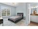 Well-lit bedroom features a large window, modern light fixture, and attached bathroom for added convenience at 501 Knights Run Ave # 5103, Tampa, FL 33602