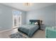Cozy bedroom with blue walls, a comfortable bed, and a door leading to an outdoor space at 501 Knights Run Ave # 5103, Tampa, FL 33602