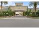 Property entrance featuring an arched entryway, covered parking, and lush landscaping at 501 Knights Run Ave # 5103, Tampa, FL 33602