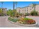 Beautiful entrance with a fountain surrounded by lush greenery and colorful flowers at 501 Knights Run Ave # 5103, Tampa, FL 33602