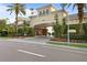 Arched entrance with manicured landscaping and covered parking at Harbour Place at 501 Knights Run Ave # 5103, Tampa, FL 33602