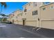 Exterior view of garages and multiple Harbour Place townhomes featuring a stucco facade at 501 Knights Run Ave # 5103, Tampa, FL 33602