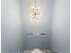 Stairway landing with modern light fixture and beach-themed artwork at 501 Knights Run Ave # 5103, Tampa, FL 33602