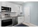 Updated kitchen with modern stainless steel appliances, white cabinetry, and tile backsplash at 501 Knights Run Ave # 5103, Tampa, FL 33602
