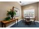 Cozy lounge area with round table, wood chairs, and decorative plants for relaxed gatherings at 501 Knights Run Ave # 5103, Tampa, FL 33602