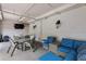 Outdoor lounge area with cushioned seating, tables, and a TV at 501 Knights Run Ave # 5103, Tampa, FL 33602