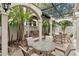 Outdoor seating area with tables, chairs, and a grilling station under a trellis at 501 Knights Run Ave # 5103, Tampa, FL 33602