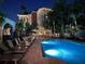 Inviting pool with lounge chairs surrounded by tropical landscaping at night in a resort setting at 501 Knights Run Ave # 5103, Tampa, FL 33602
