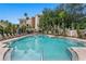 Inviting community pool surrounded by lounge chairs and lush landscaping for relaxation at 501 Knights Run Ave # 5103, Tampa, FL 33602