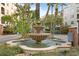 Tiered fountain surrounded by lush landscaping in a circular brick-paved area at 501 Knights Run Ave # 5103, Tampa, FL 33602