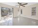 The bedroom features terrazzo flooring, sliding glass door access to the backyard, and a ceiling fan at 5010 109Th N Way, St Petersburg, FL 33708