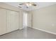 Bright bedroom featuring neutral walls, light gray flooring and a ceiling fan at 5010 109Th N Way, St Petersburg, FL 33708