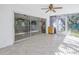The Florida room includes ceramic tile floor, ceiling fan, and sliding glass door to the backyard at 5010 109Th N Way, St Petersburg, FL 33708